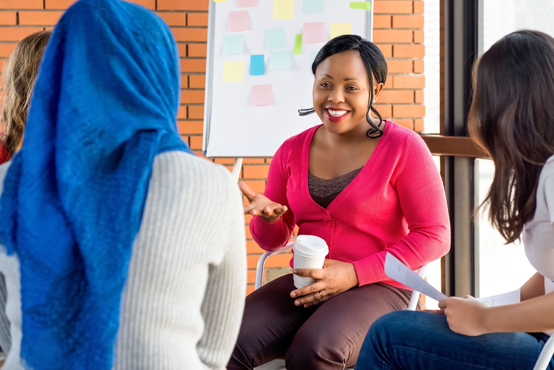 Diverse group of women in colorful clothes at the meeting
